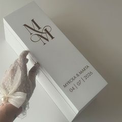 A time capsule for storing alcohol with initials for a wedding