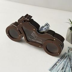 Interior piggy bank in the shape of a motorcycle with an inscription