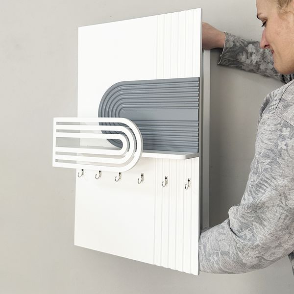 Designer wall-mounted key holder under the shield
