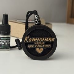 A humorous car air freshener for a woman