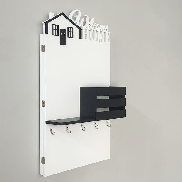 Wall-mounted key holder on a shield in black and white colors
