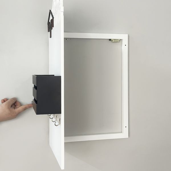 Wall-mounted key holder on a shield in black and white colors