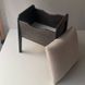 A shoe ottoman with a drawer for small items