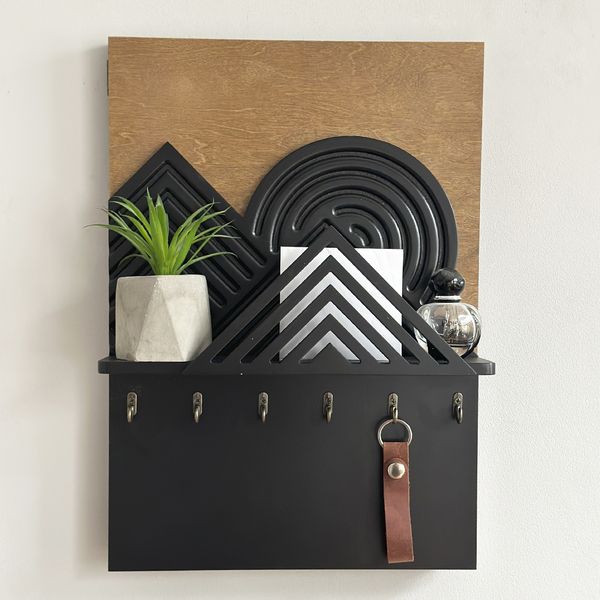 Designer key holder with a shelf on the shield