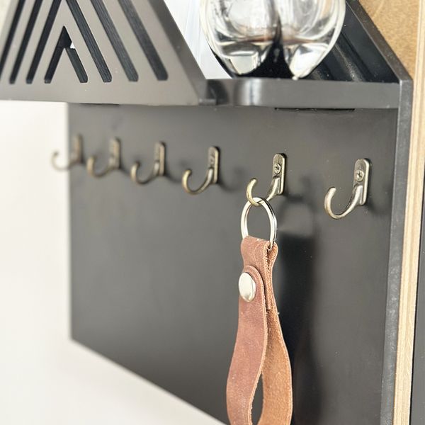 Designer key holder with a shelf on the shield