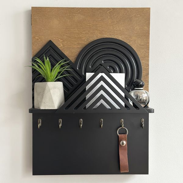 Designer key holder with a shelf on the shield