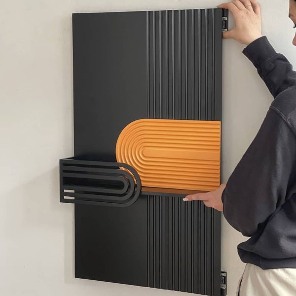 Designer wall key holder under the shield with a slider system