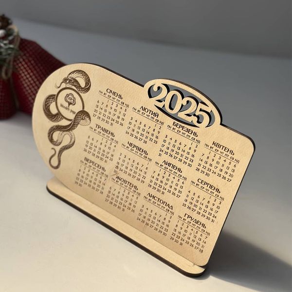 Desk calendar for 2025 with snake and logo