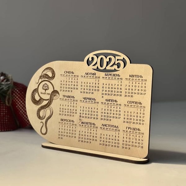 Desk calendar for 2025 with snake and logo