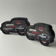 A piggy bank in the shape of a tipping machine with a logo