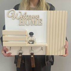 Key holder on a shield in beige color