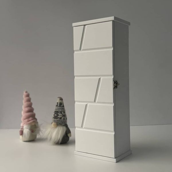 Designer wooden key holder with a door on the wall