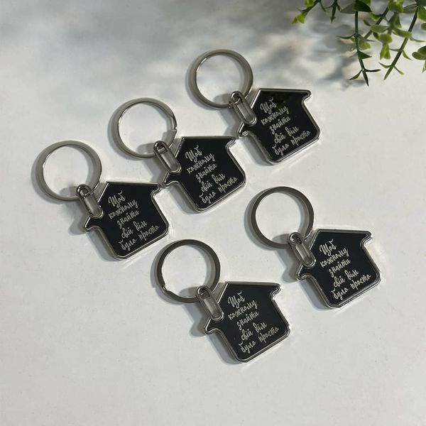 Metal keychain in the shape of a house with engraving