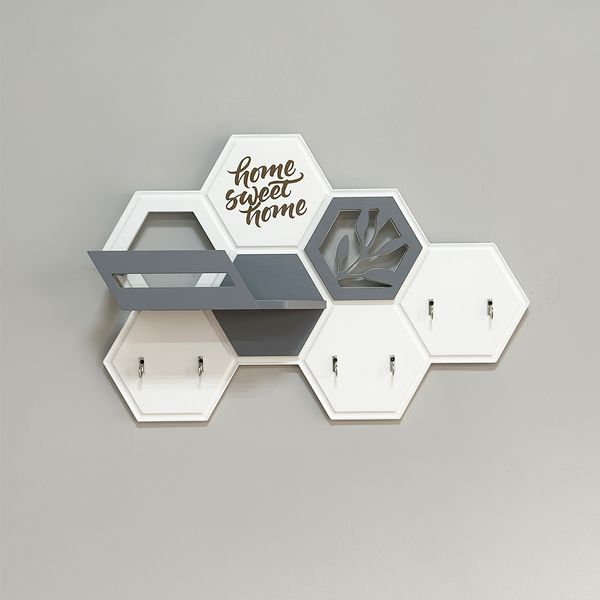 Designer key holder with a honeycomb-shaped shelf