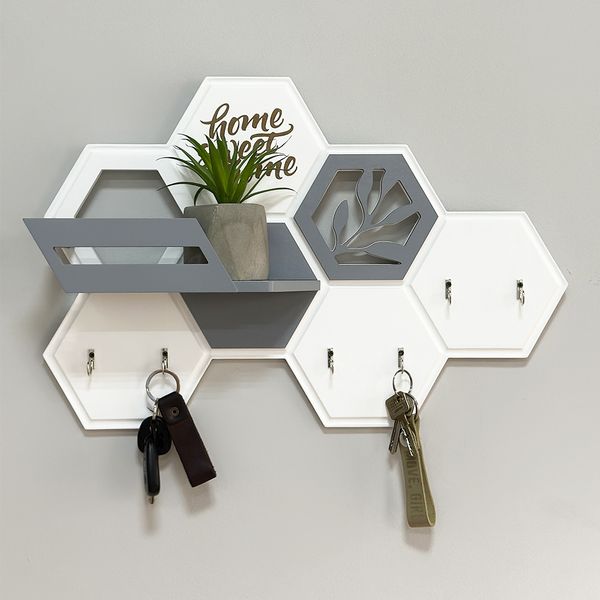 Designer key holder with a honeycomb-shaped shelf