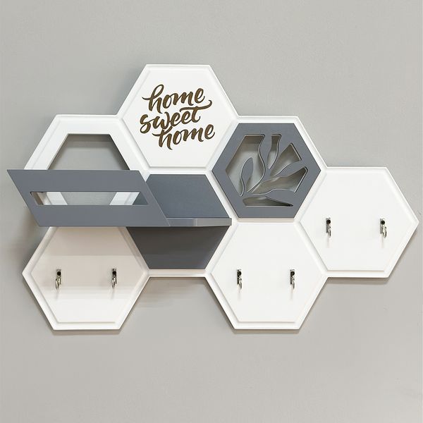 Designer key holder with a honeycomb-shaped shelf