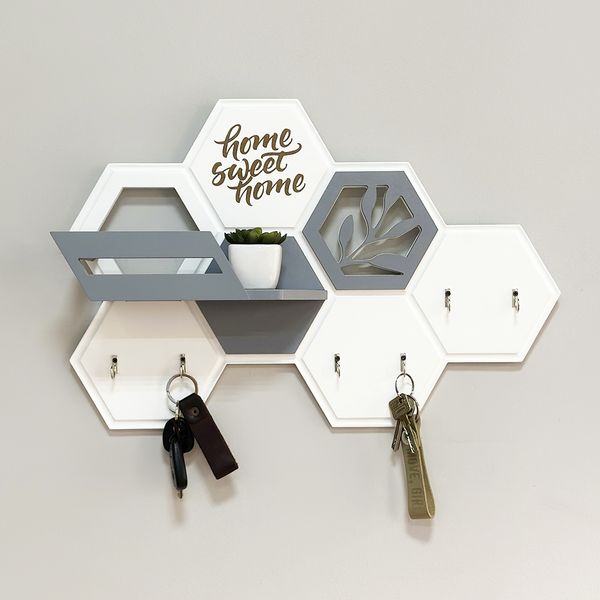 Designer key holder with a honeycomb-shaped shelf