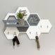 Designer key holder with a honeycomb-shaped shelf