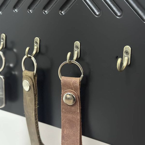 Key holder with a shelf on the shield
