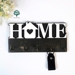 Key holder in the hallway with the phrase HOME