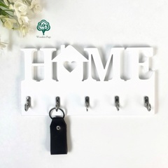 Small key holder in the hallway with the phrase HOME