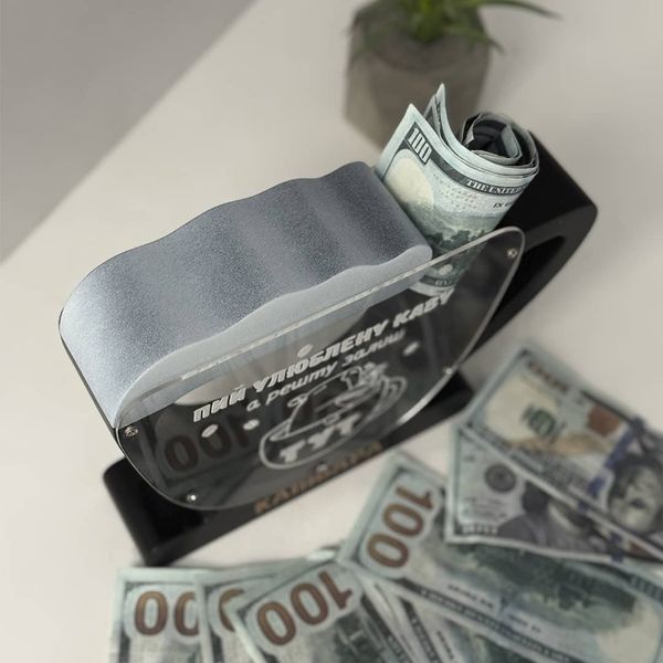 A coffee shop tip jar with an inscription
