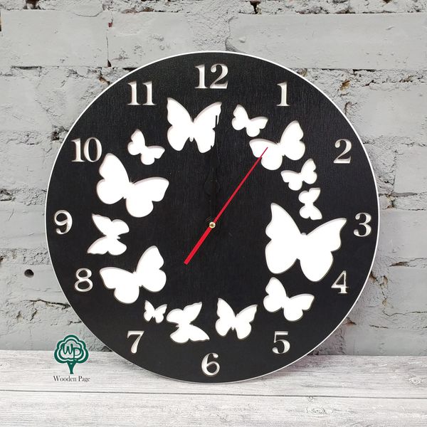 Conceptual wall clock with butterflies in black and white