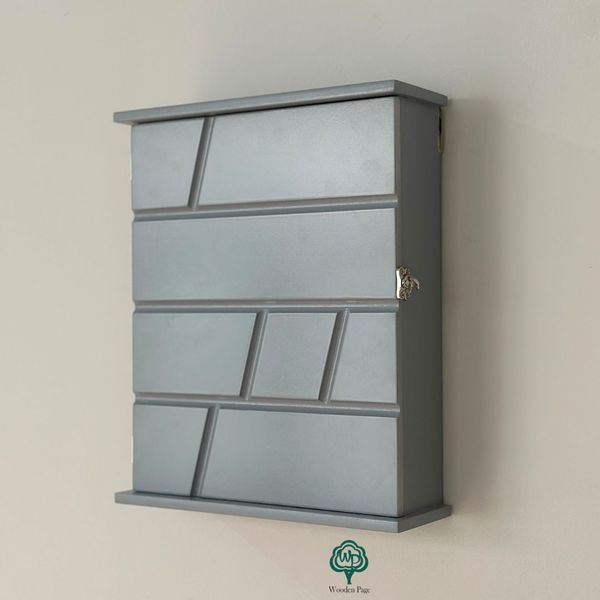 Designer key holder with a door in dark blue