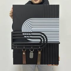Designer key holder under the shield in black and gray