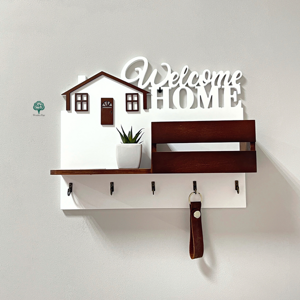 Wooden key holder on the wall with the inscription Welcome home
