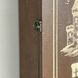 Wall mounted key holder with a door with a picture of a castle